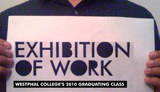 Photograph of man holding paper that say Exhibition of Work